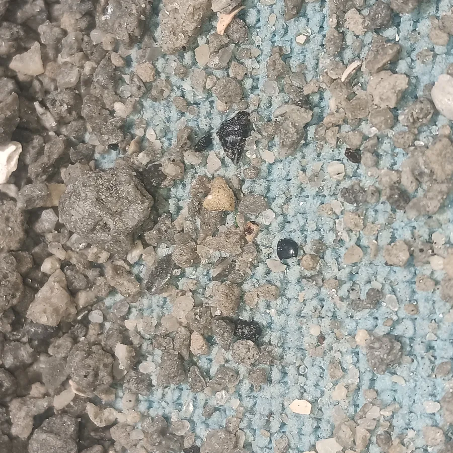 ASA Digital Art photo of crushed sediment and gravel, shown for context. No site is named, and no claim is made about what it contains. Collected lawfully over about a decade as a personal hobby, on break and lunch time while working on construction projects, with authorization to remove non-building material that would otherwise have been thrown out or buried under pavement; not from any park, preserve or public land where collecting is restricted.